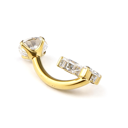 Side view of a gold navel ring