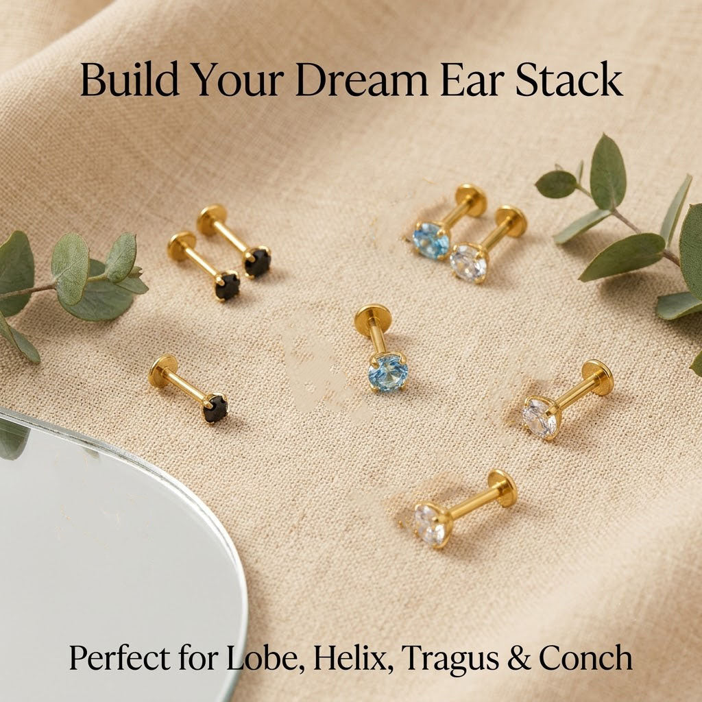 Curated minimal ear stack styling featuring a gold titanium 4-prong zircon flat back stud in the helix alongside delicate gold hoops.