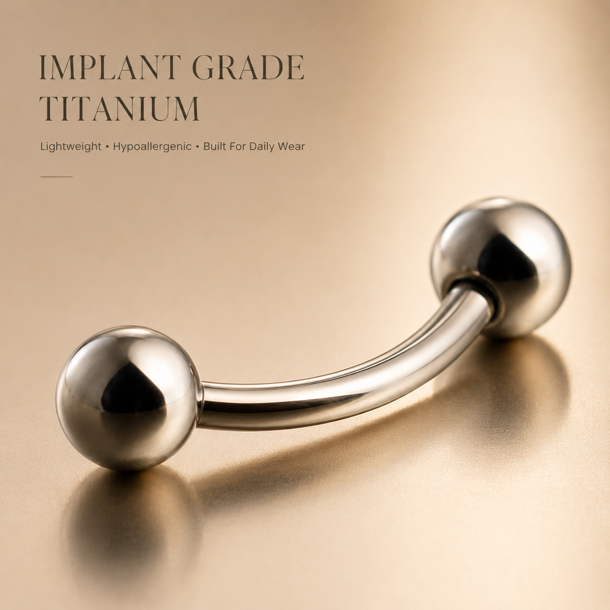 Macro detail of implant grade titanium curved barbell showing mirror polished finish and precision craftsmanship