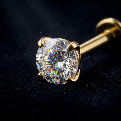 Extreme macro photography highlighting the brilliant zircon fire of clear, black, and sky blue stones in 4-prong gold titanium flat back settings.