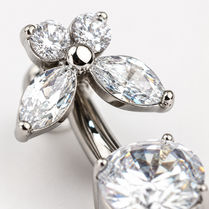 Macro close up of zircon flower belly button ring showing titanium finish and sparkling stone details