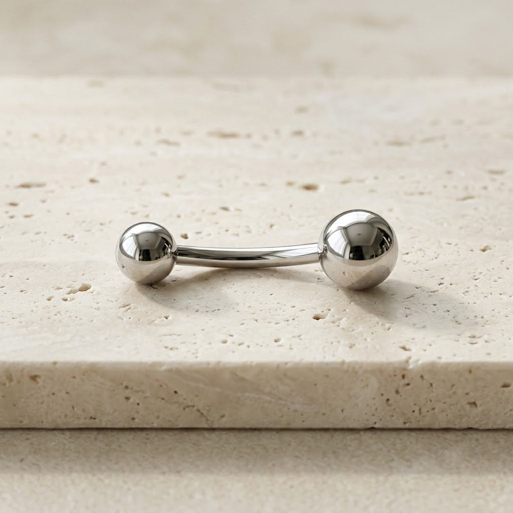 Premium high-polished mirror finish implant-grade titanium curved navel barbell, 14G, 3/8 inch.