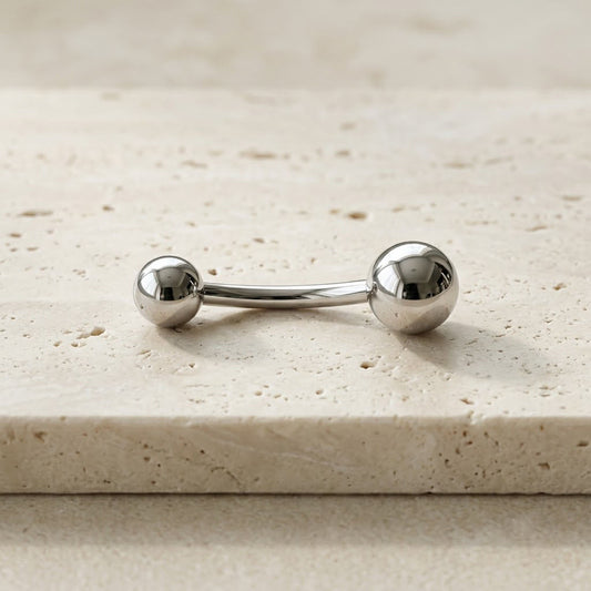 Premium high-polished mirror finish implant-grade titanium curved navel barbell, 14G, 3/8 inch.