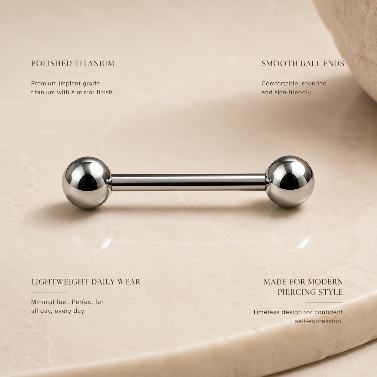 Macro detail of polished titanium ball straight barbell piercing jewelry