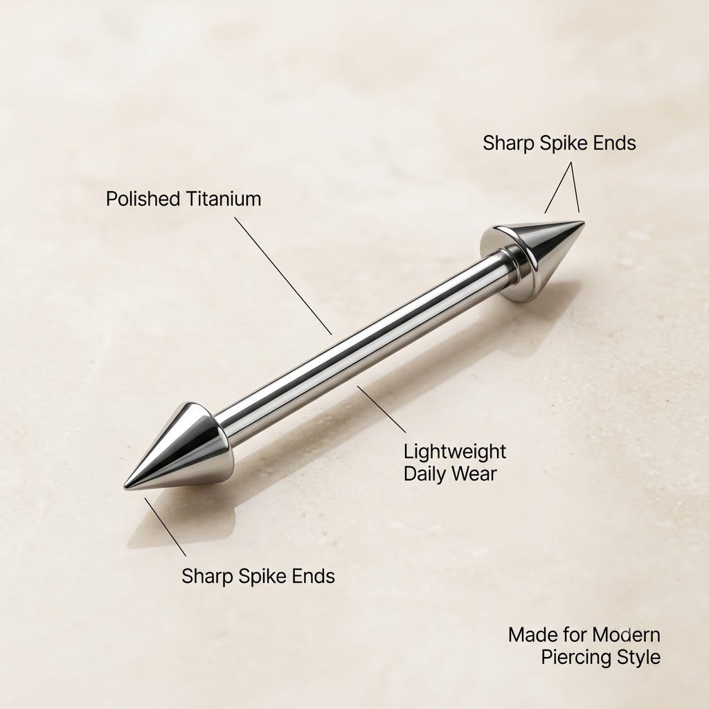 Close up of polished titanium spike straight barbell with cone ends