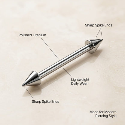 Close up of polished titanium spike straight barbell with cone ends