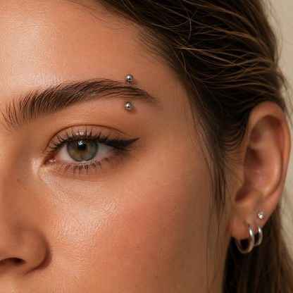 Young woman wearing a titanium ball straight barbell eyebrow piercing