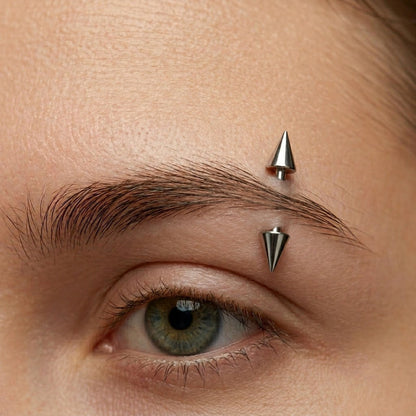 Titanium spike eyebrow ring worn on a healed eyebrow piercing